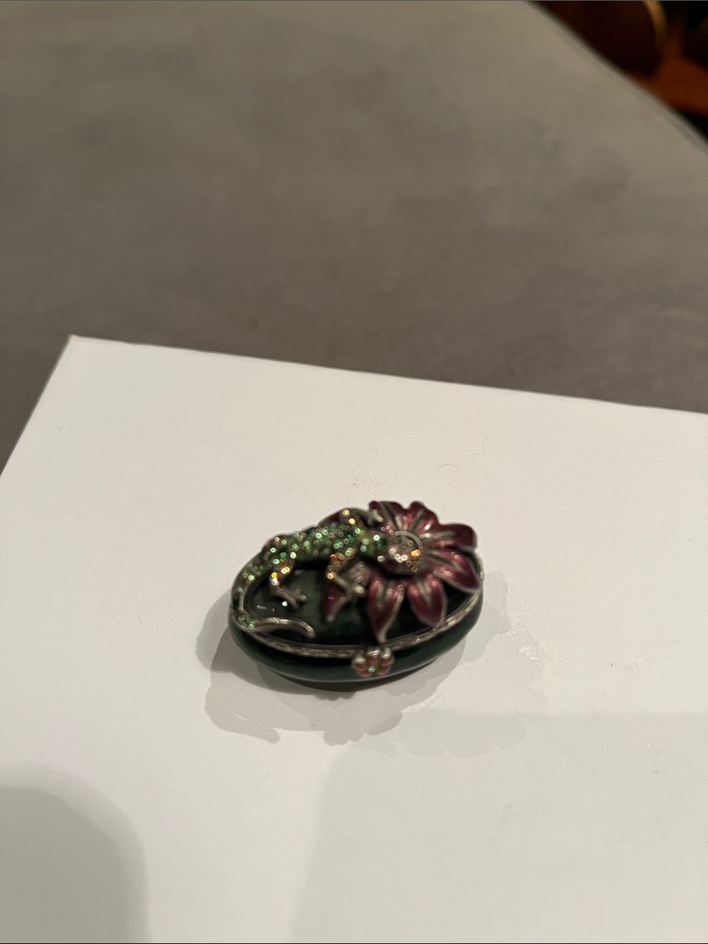 Jay Strongwater enamel box with tiny green salamander and pink flower.